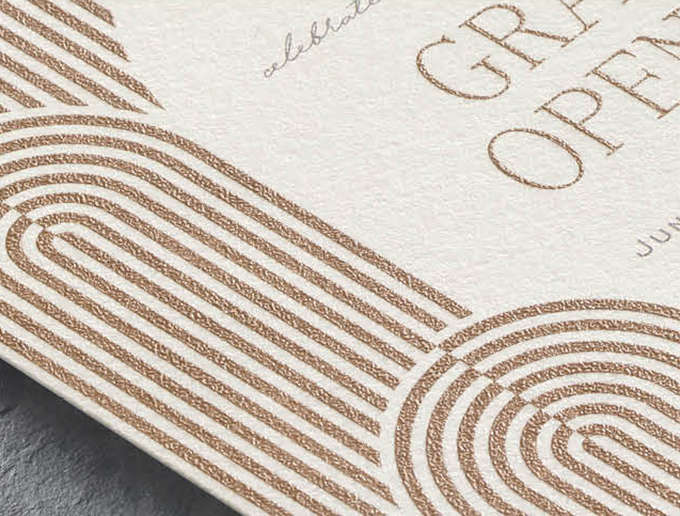 Thermography Print Closeup image of a custom invitation with a modern arch design in copper thermography print