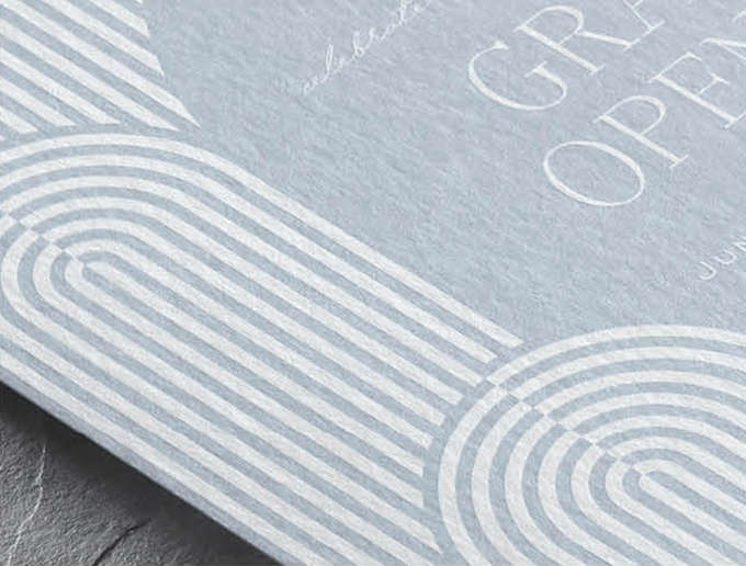 White Ink Printing Closeup image of a contemporary arch design in White Ink on a light blue custom invitation